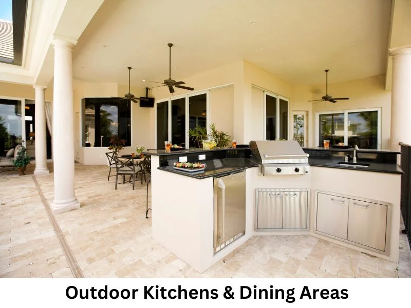 Contemporary outdoor kitchen and grill area beside a paved patio