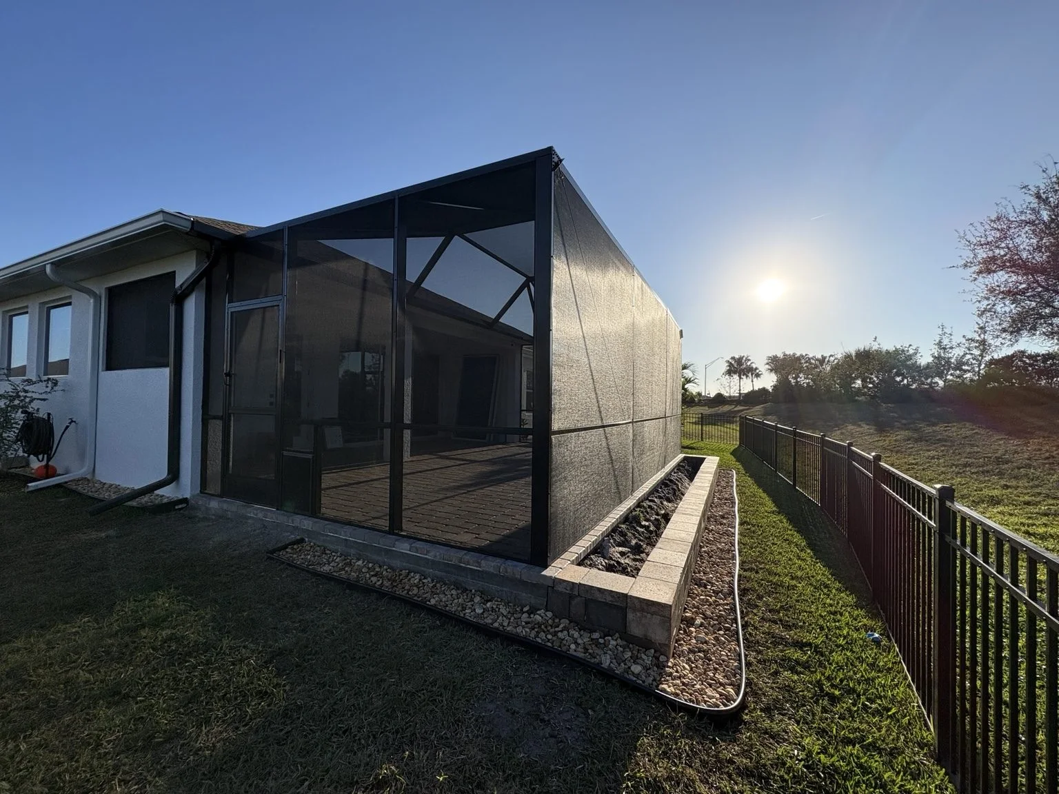 Finished dark screen enclosure at a Florida home in late afternoon